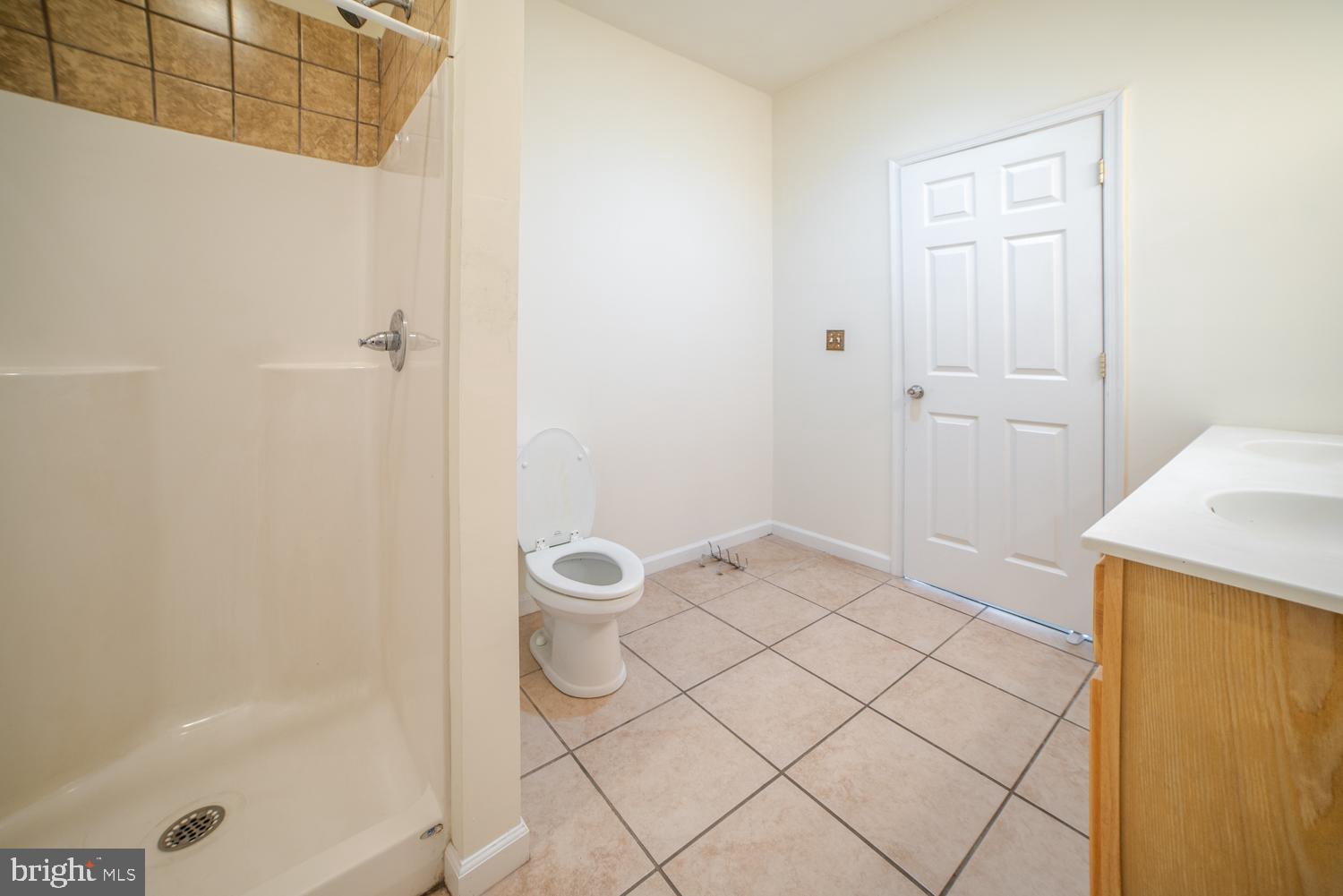 1838 North 16th Street, Unit 2 Philadelphia, PA 19121 - Photo 15 of 17 a bathroom with a granite countertop sink a toilet and a mirror
