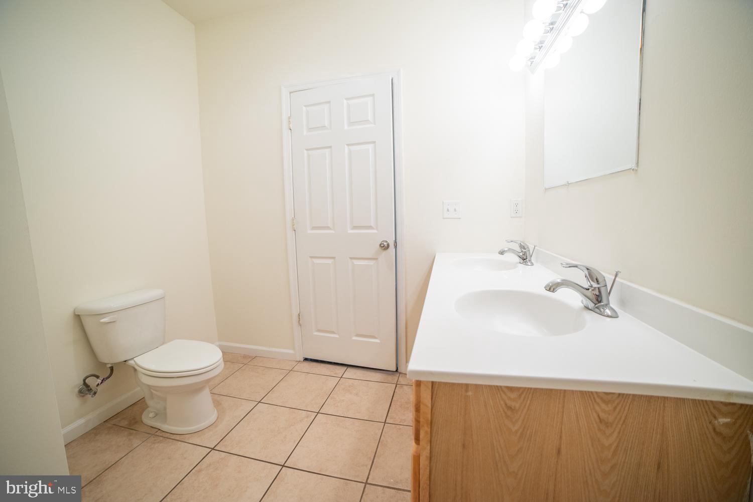 1838 North 16th Street, Unit 2 Philadelphia, PA 19121 - Photo 5 of 17 a bathroom with a sink a toilet and a mirror