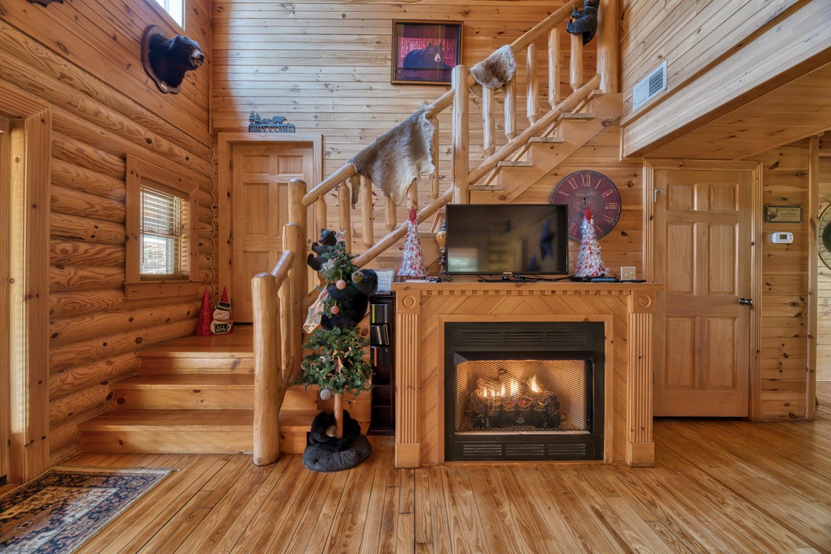 3124 Smoky Ridge Way Sevierville, TN 37862 - Photo 5 of 14 a living room with wooden floors and a fireplace