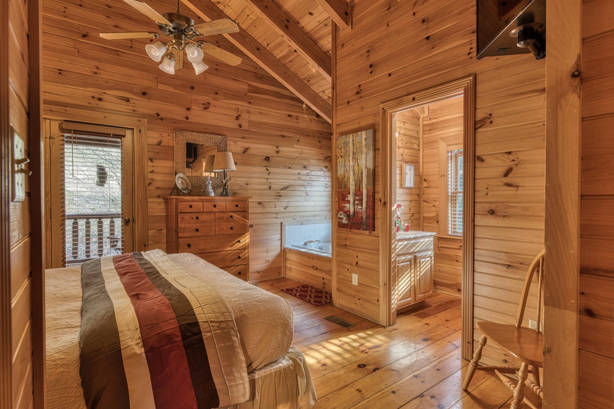 3124 Smoky Ridge Way Sevierville, TN 37862 - Photo 7 of 14 a bedroom with a bed and wooden floor