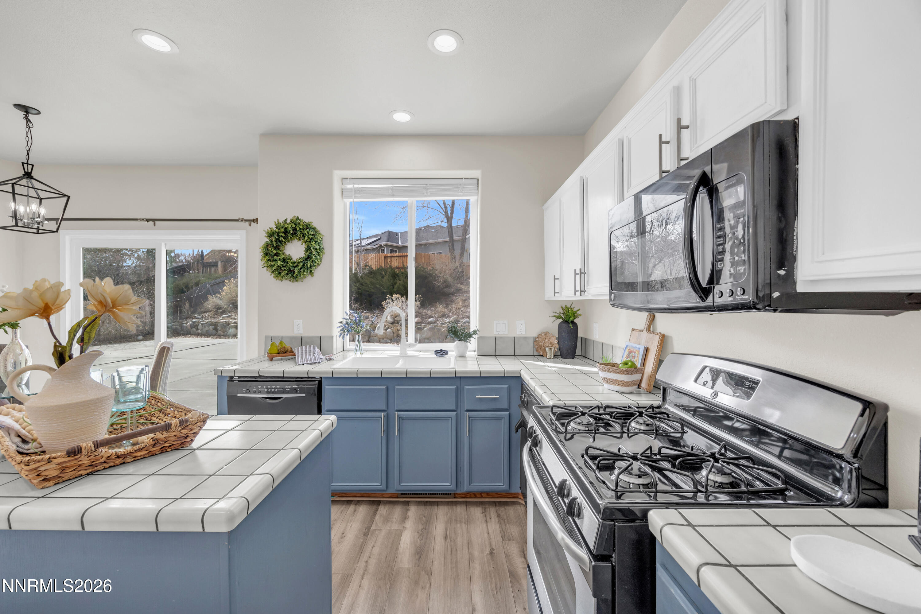 5420 Brittania Drive Reno, NV 89523 - Photo 12 of 25 a kitchen with stainless steel appliances granite countertop a stove a sink and a microwave