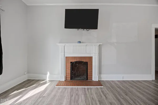 a living room with a fireplace and a flat screen tv