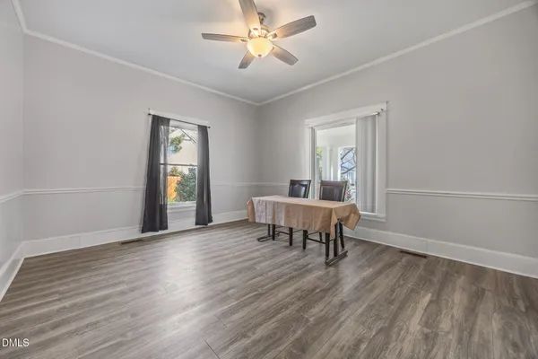 a view of a workspace and wooden floor in a room