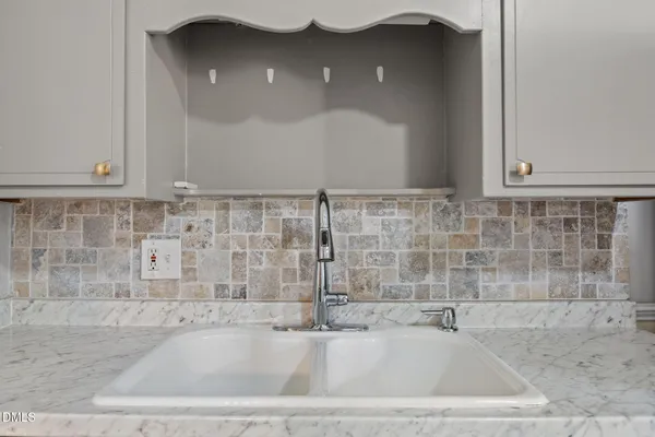 a bathroom with a shower sink and mirror
