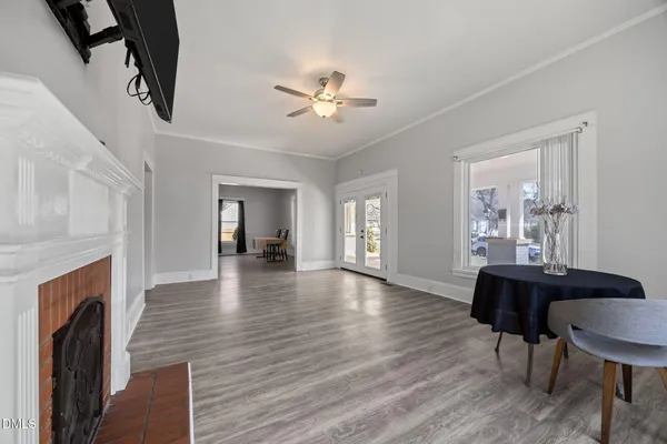 an empty room with wooden floor and white walls