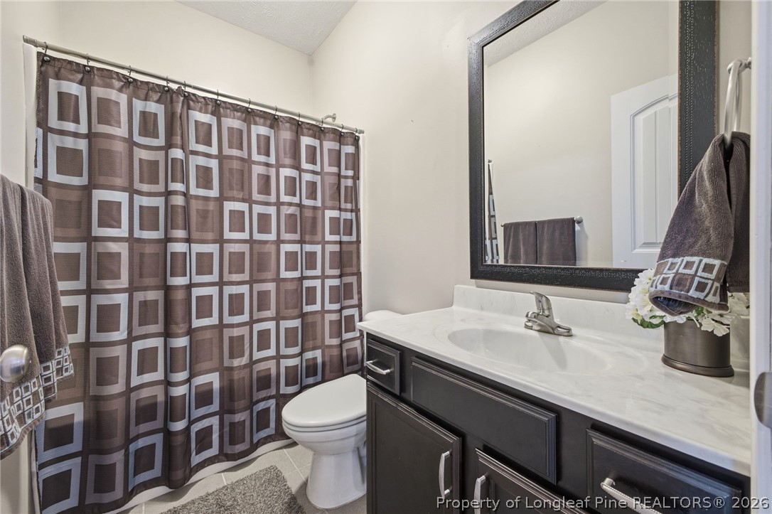 2589 June Johnson Road Raeford, NC 28376 - Photo 27 of 49 a bathroom with a sink a toilet and shower