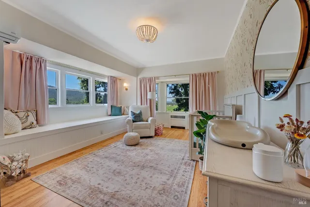 a view of a porch with chairs and floor to ceiling window