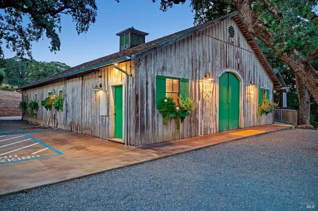 a bathroom with a granite countertop sink a toilet a mirror a vanity and shower