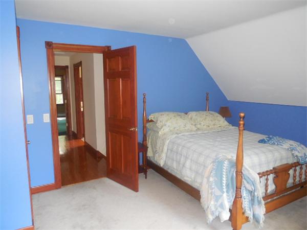 36 Washington Road Brimfield, MA 01010 - Photo 12 of 25 a bedroom with a bed and wooden floor