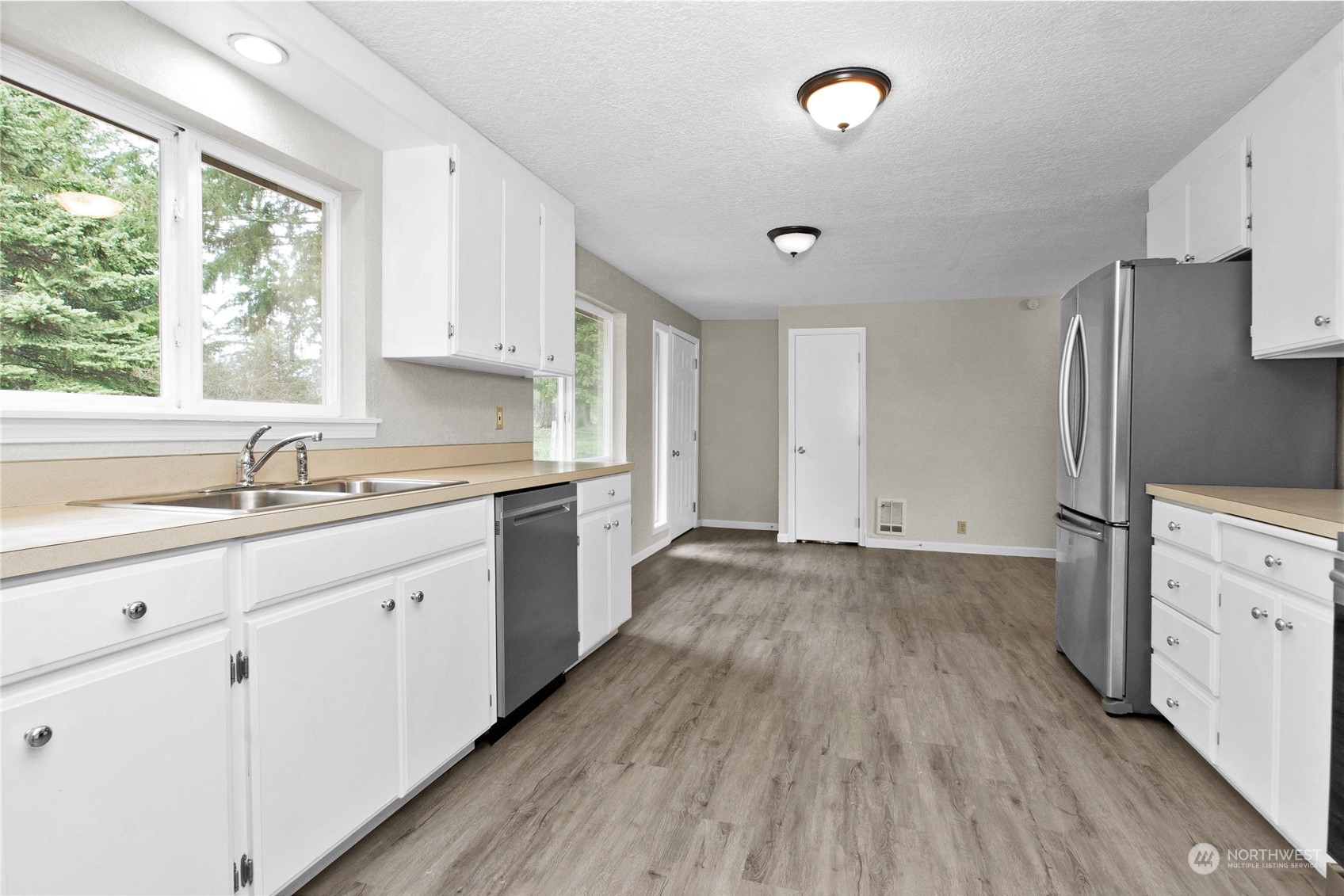 151 Ramsey Road Chehalis, WA 98532 - Photo 5 of 25 a kitchen with a sink wooden floor and stainless steel appliances