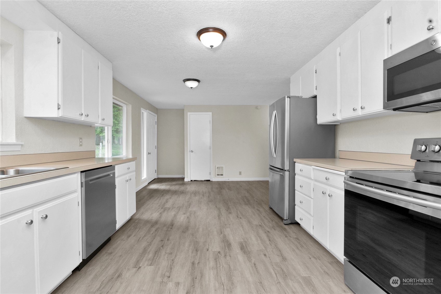 151 Ramsey Road Chehalis, WA 98532 - Photo 6 of 25 a kitchen with cabinets wooden floor and stainless steel appliances