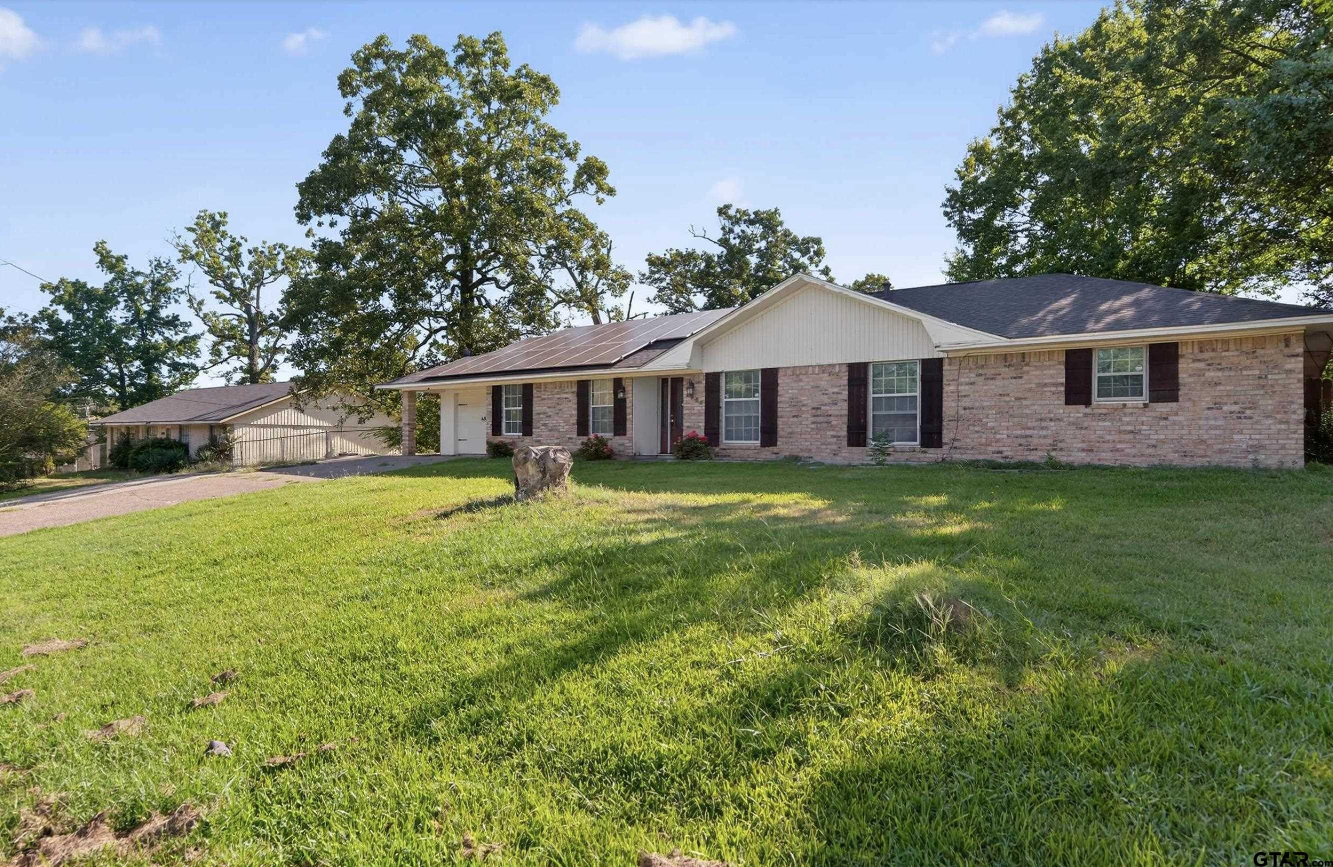 3408 Jackson Avenue Tyler, TX 75705 - Photo 1 of 45 a house with a big yard and palm trees