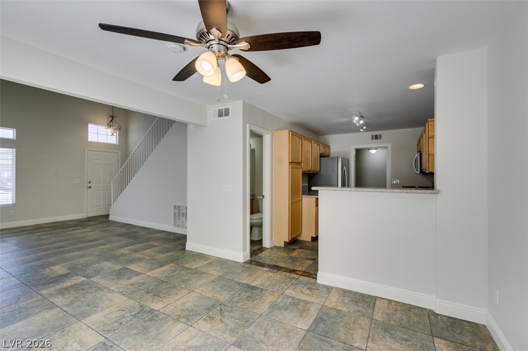 200 Luninborg Street Henderson, NV 89074 - Photo 39 of 40 A well-lit living area features tiled flooring and an open flow to the adjacent kitchen.