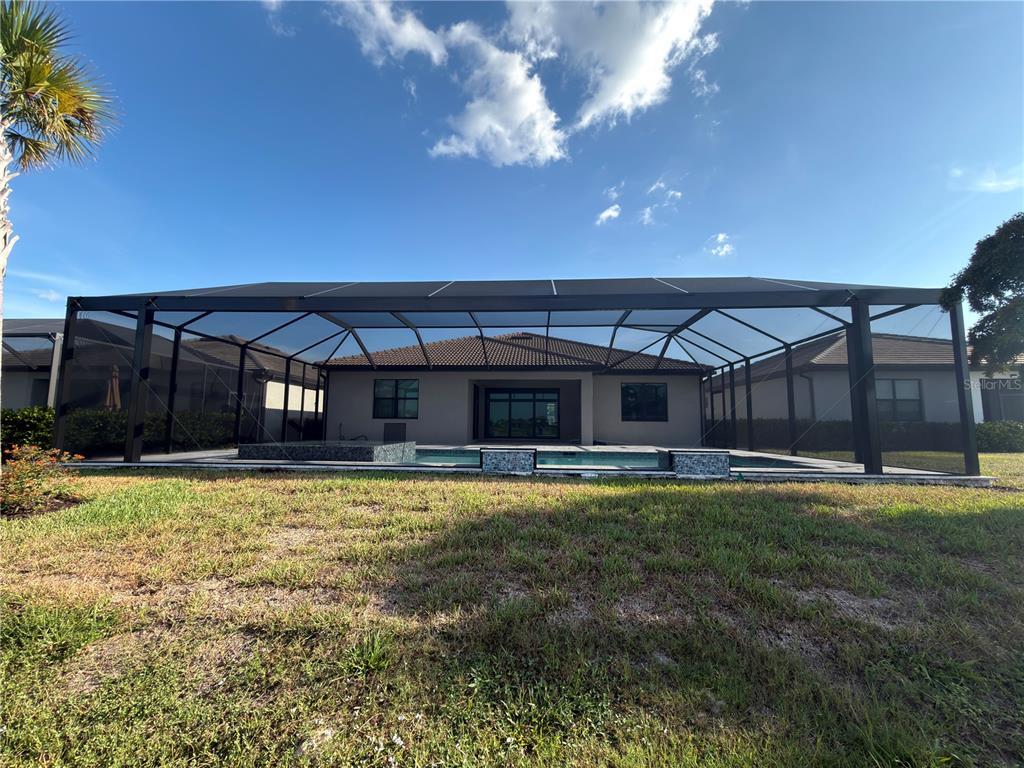 18334 Ridgeline Drive Estero, FL 33928 - Photo 21 of 30 a view of a house with a yard