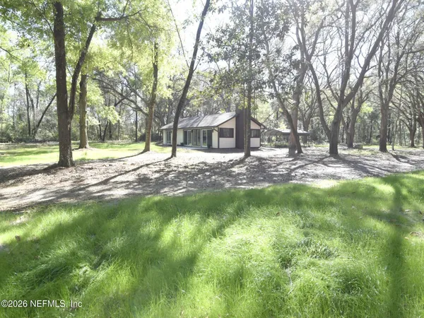 a view of a house with a backyard