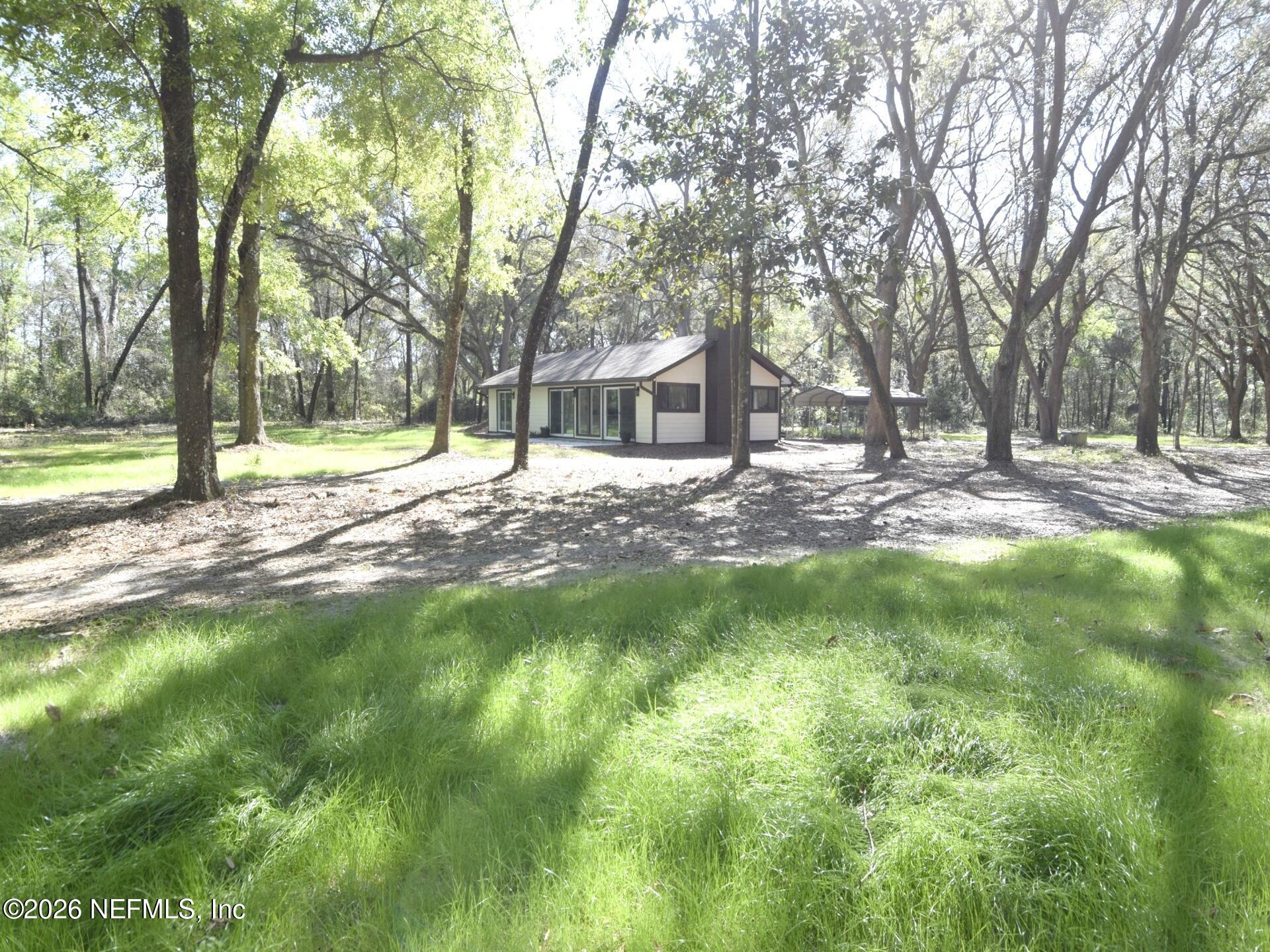 16684 Oak Hill Road Hilliard, FL 32046 - Photo 1 of 33 a view of a house with a backyard