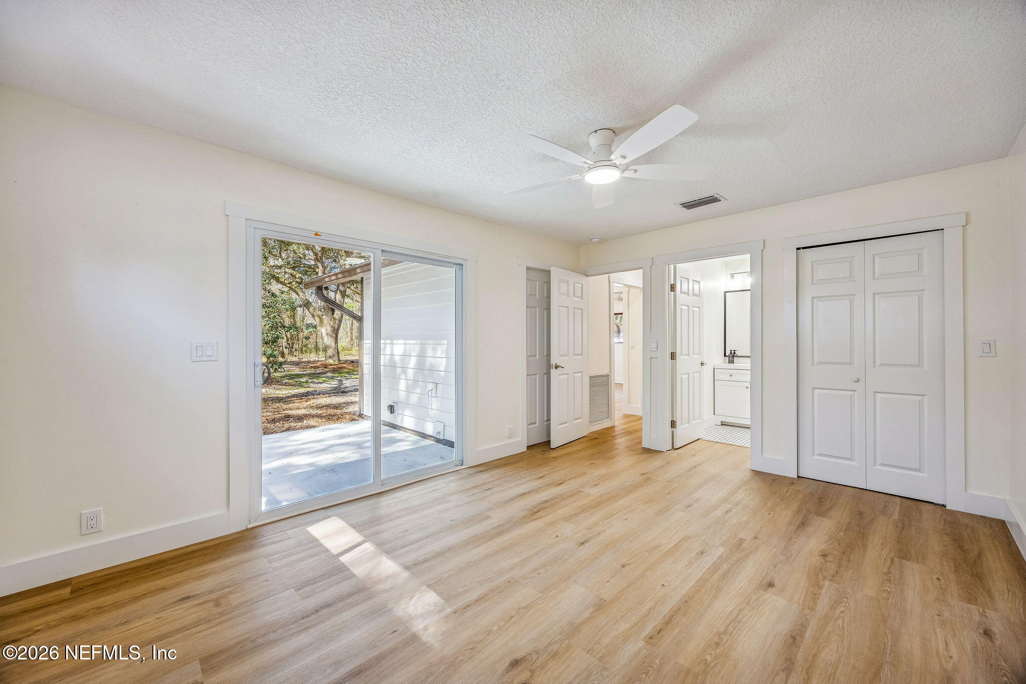 16684 Oak Hill Road Hilliard, FL 32046 - Photo 12 of 33 a view of empty room with wooden floor and fan