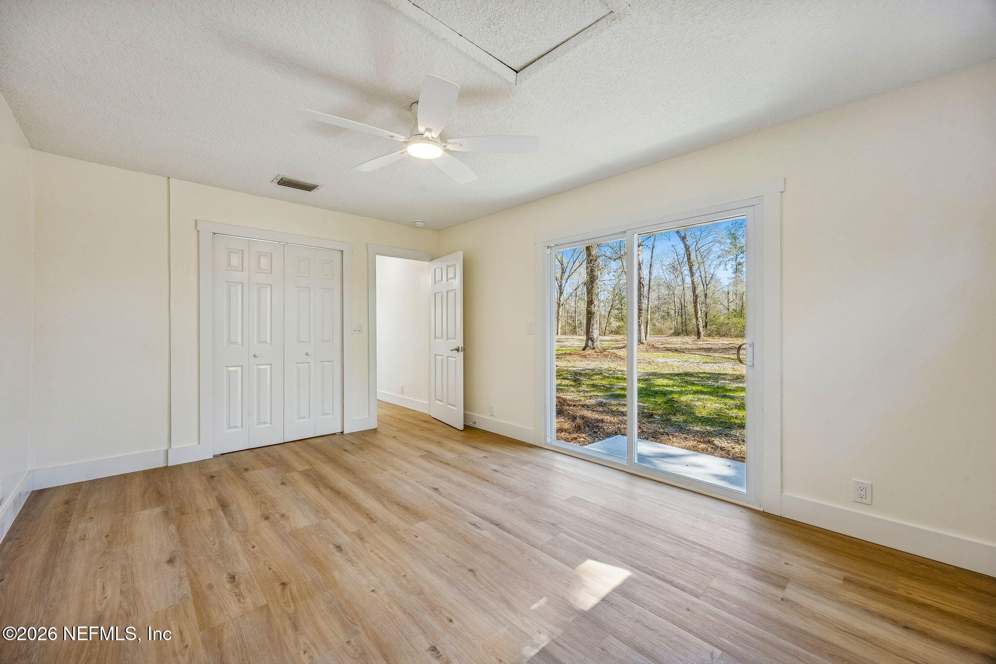 16684 Oak Hill Road Hilliard, FL 32046 - Photo 13 of 33 wooden floor in an empty room with a window