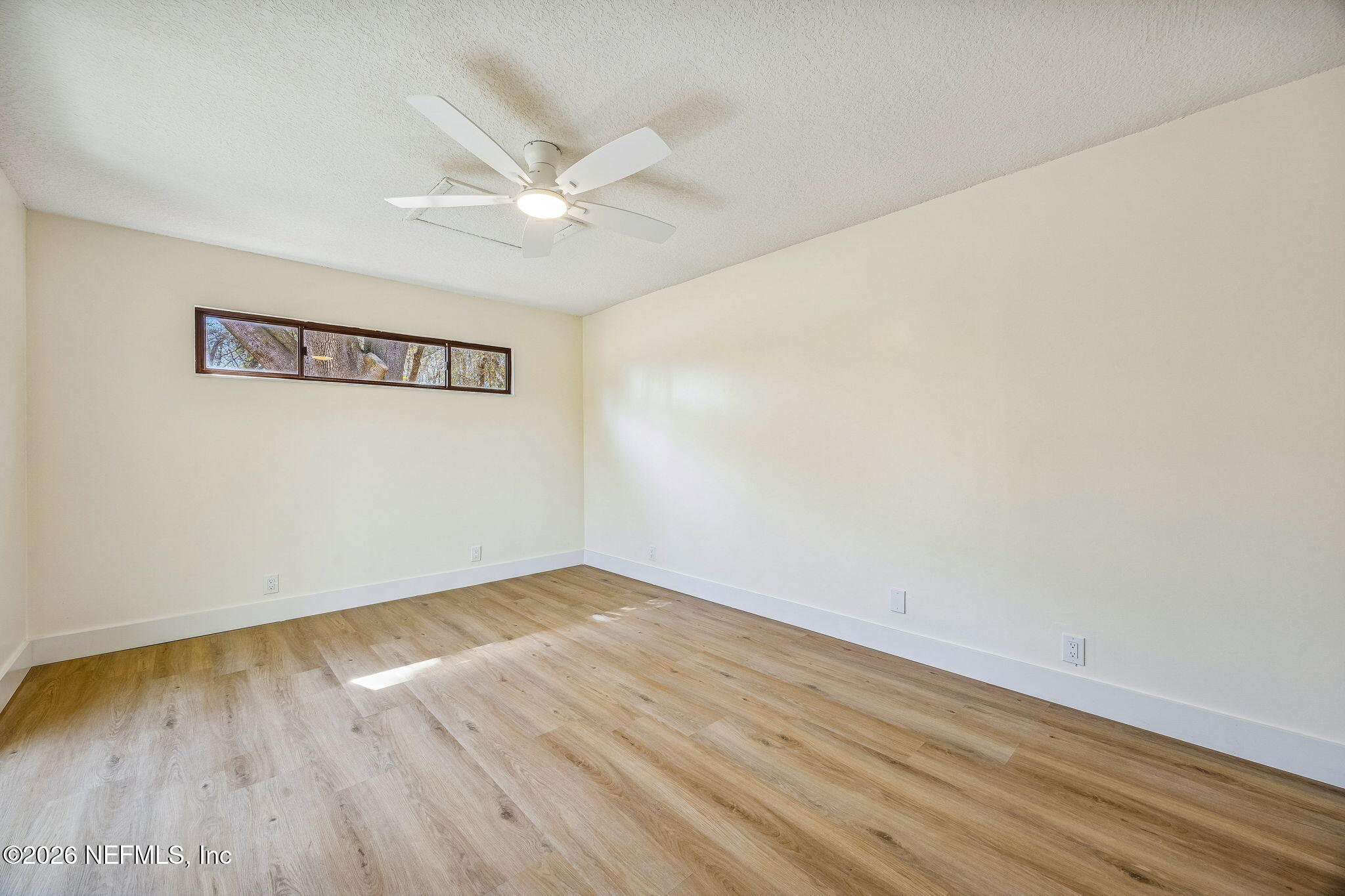 16684 Oak Hill Road Hilliard, FL 32046 - Photo 14 of 33 an empty room with wooden floor and windows