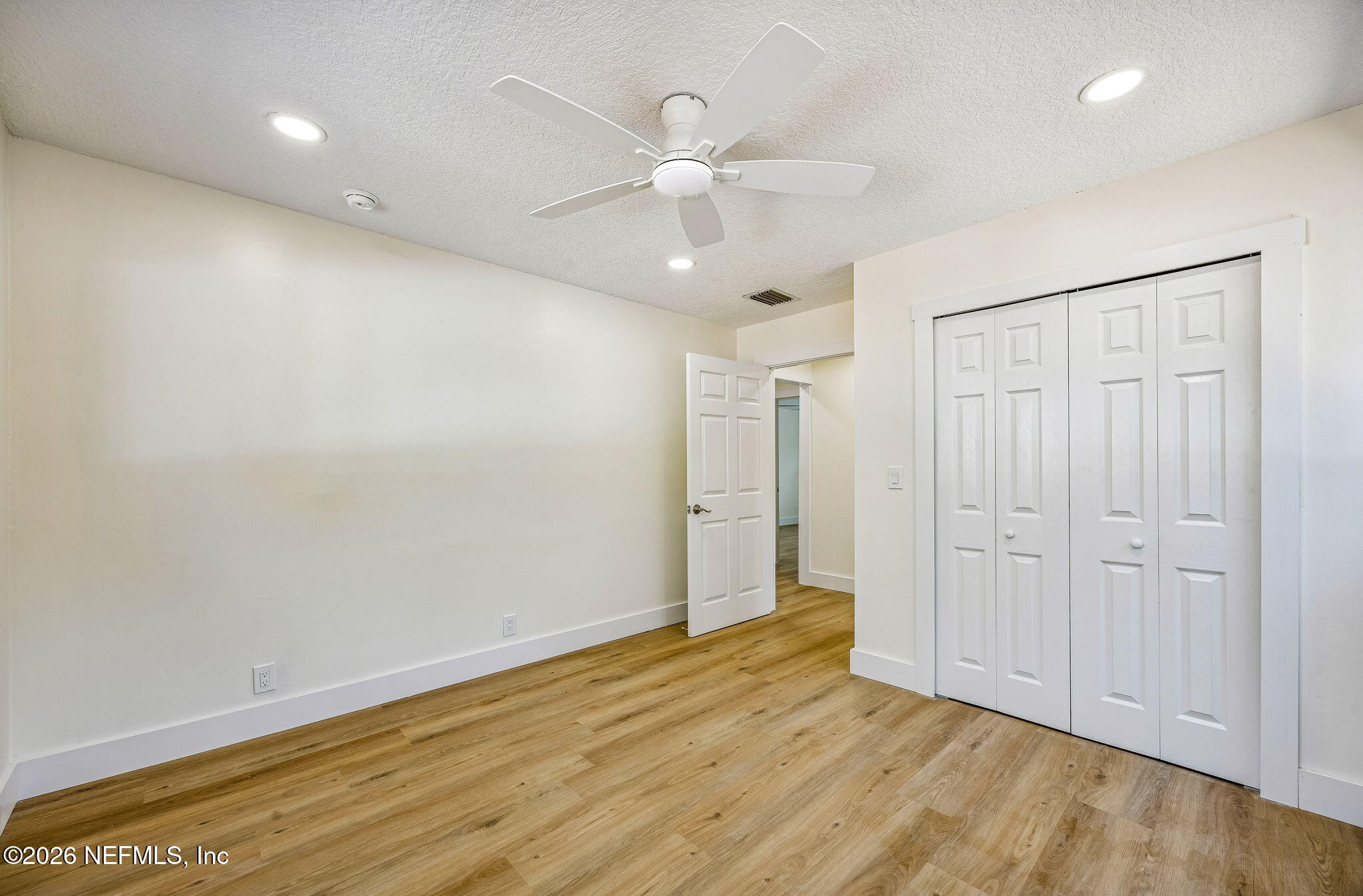 16684 Oak Hill Road Hilliard, FL 32046 - Photo 15 of 33 an empty room with wooden floor and ceiling fan