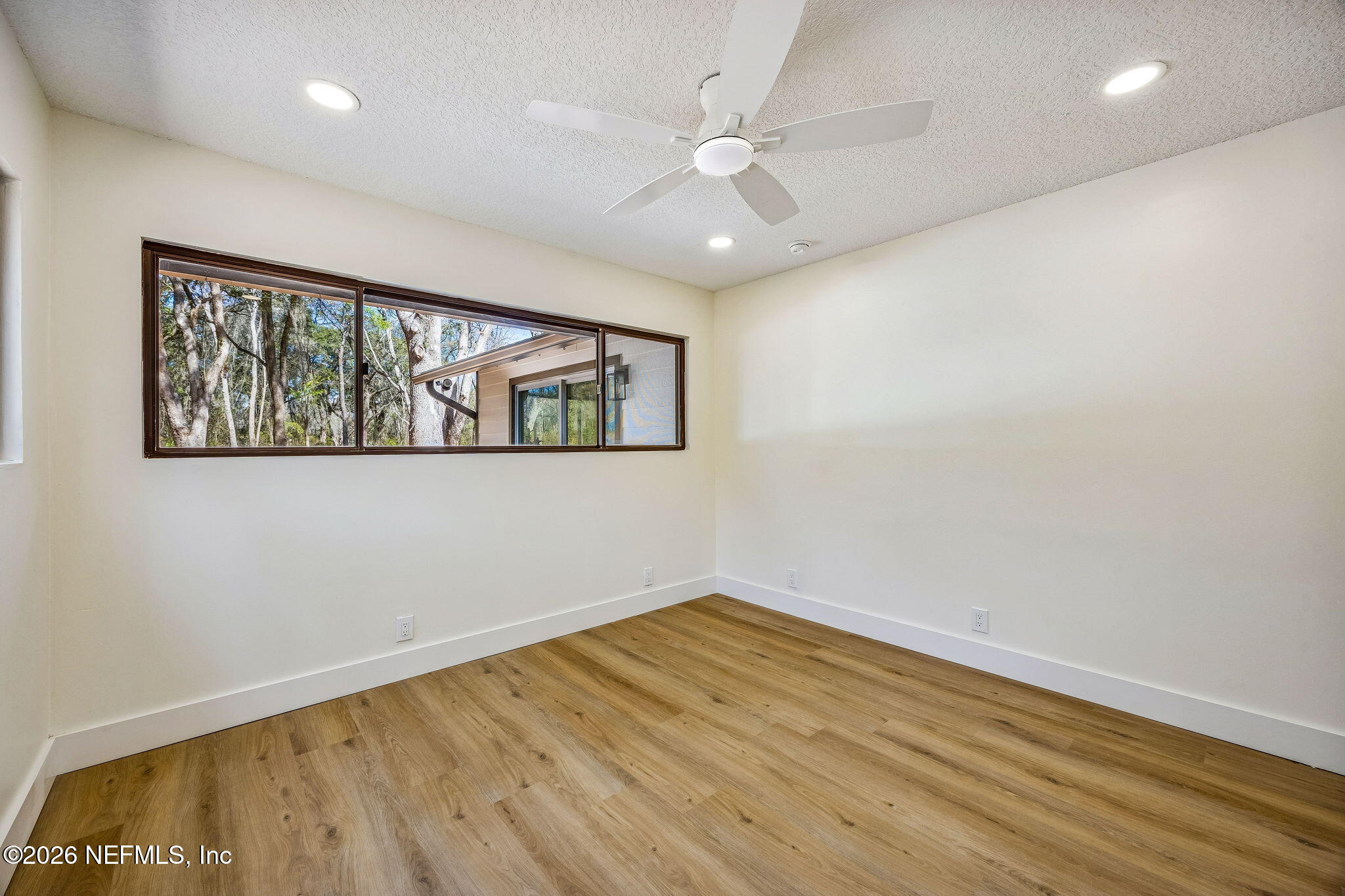 16684 Oak Hill Road Hilliard, FL 32046 - Photo 16 of 33 an empty room with wooden floor and windows