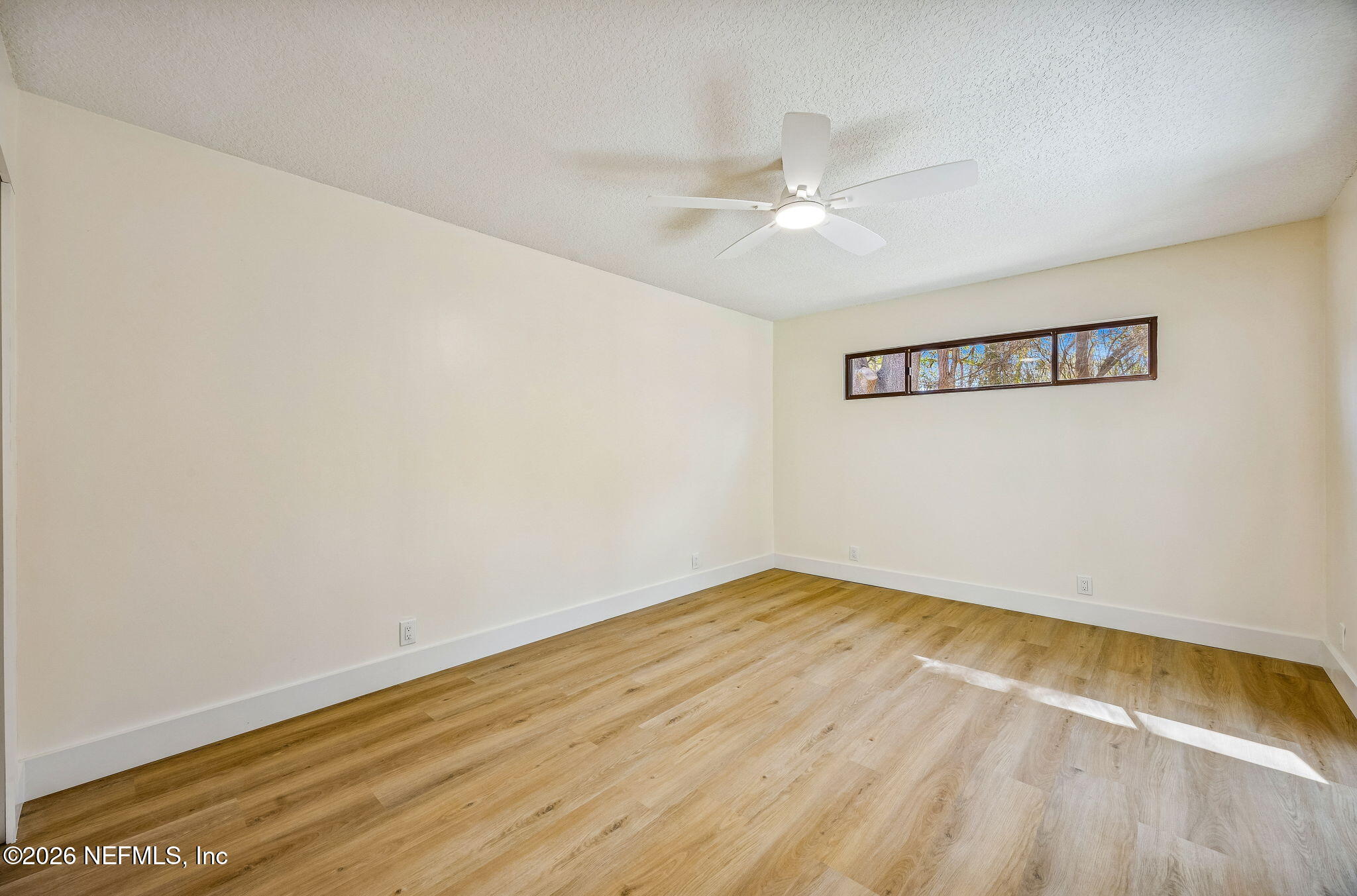 16684 Oak Hill Road Hilliard, FL 32046 - Photo 17 of 33 an empty room with a window and ceiling fan