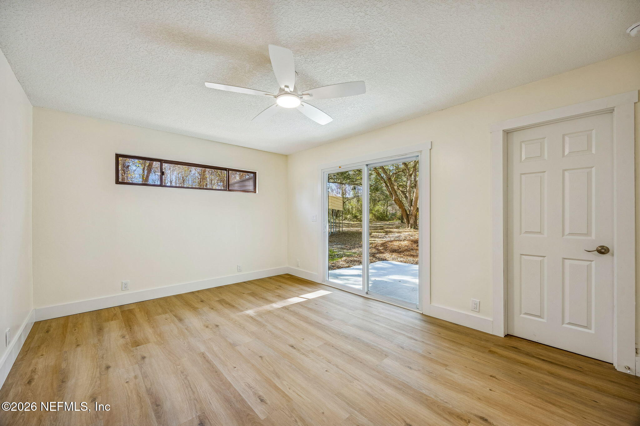 16684 Oak Hill Road Hilliard, FL 32046 - Photo 18 of 33 wooden floor in an empty room with a window