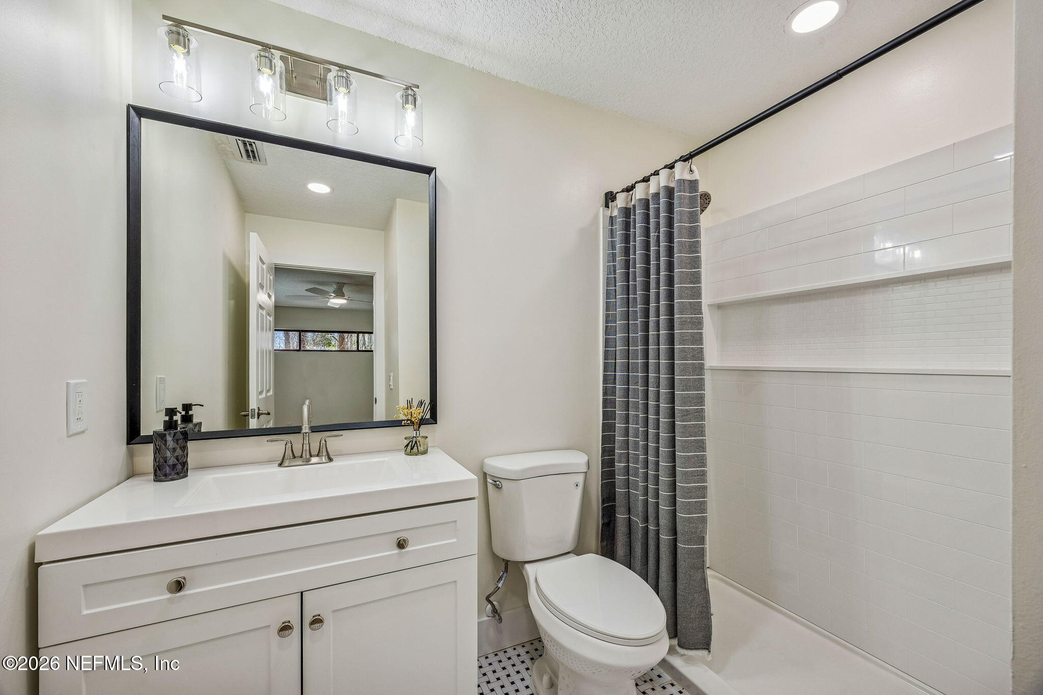 16684 Oak Hill Road Hilliard, FL 32046 - Photo 19 of 33 a bathroom with a toilet a sink and mirror