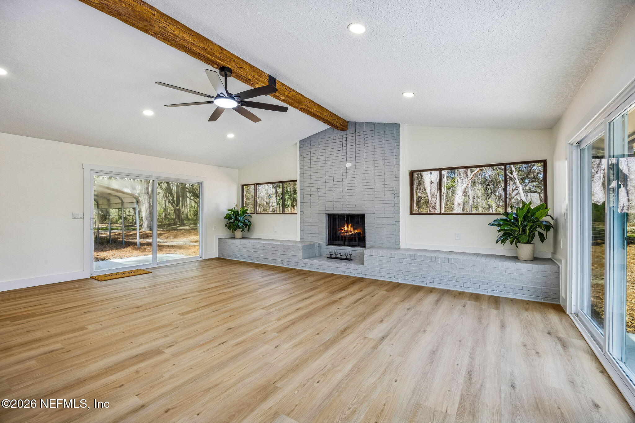 16684 Oak Hill Road Hilliard, FL 32046 - Photo 5 of 33 a view of empty room with wooden floor and fan