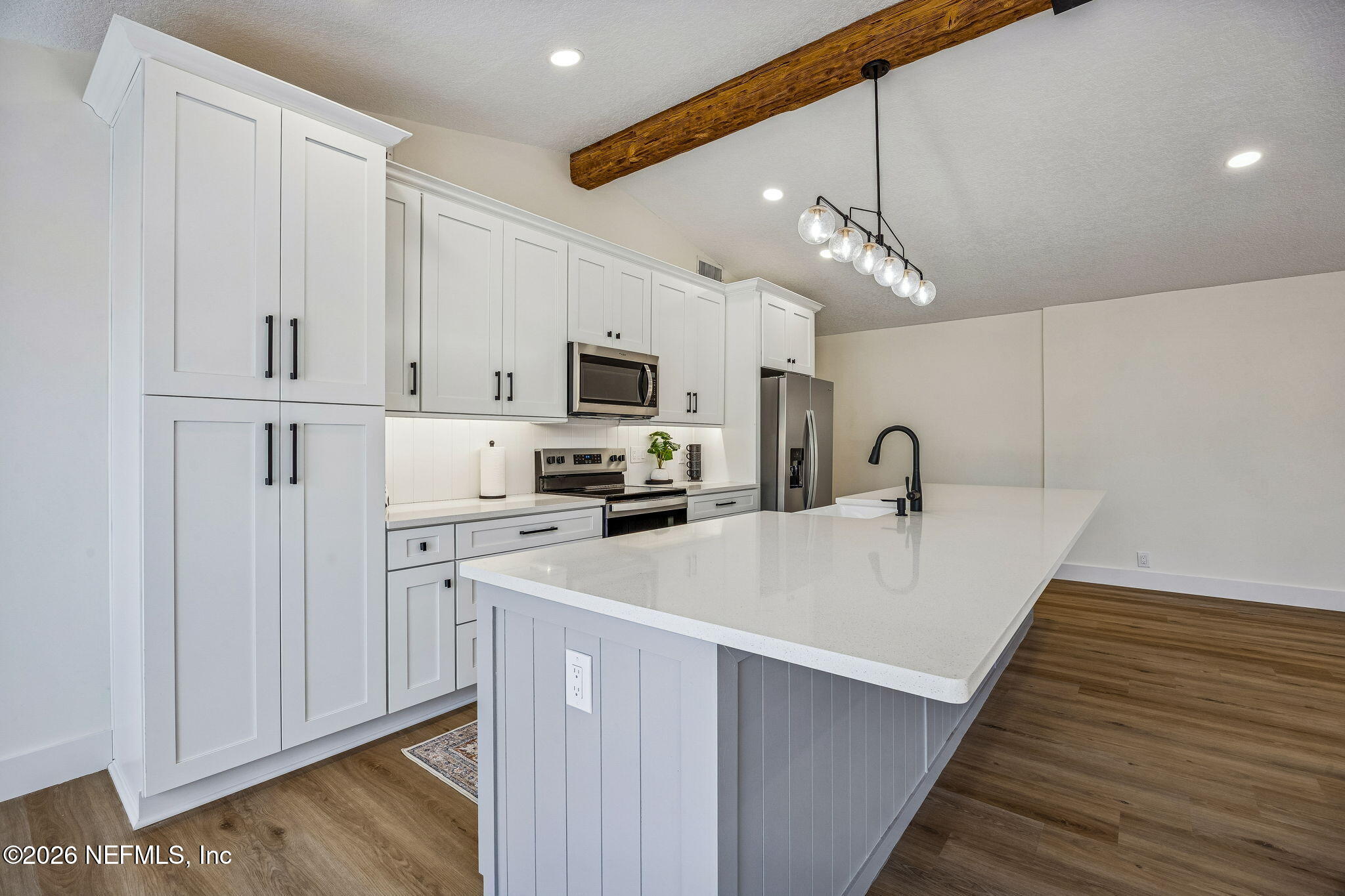 16684 Oak Hill Road Hilliard, FL 32046 - Photo 8 of 33 a large white kitchen with sink and stainless steel appliances