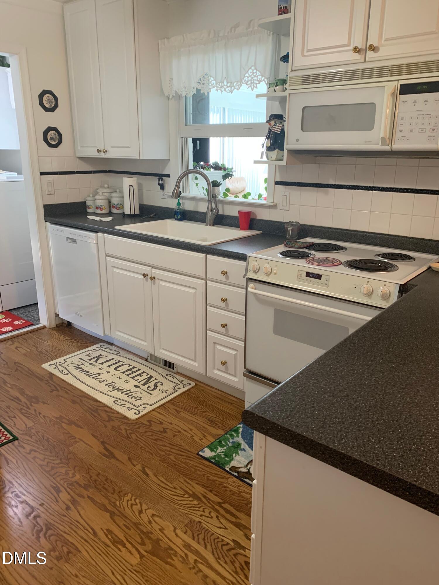 133 Sam Horton Road Louisburg, NC 27549 - Photo 5 of 15 a kitchen with cabinets and appliances