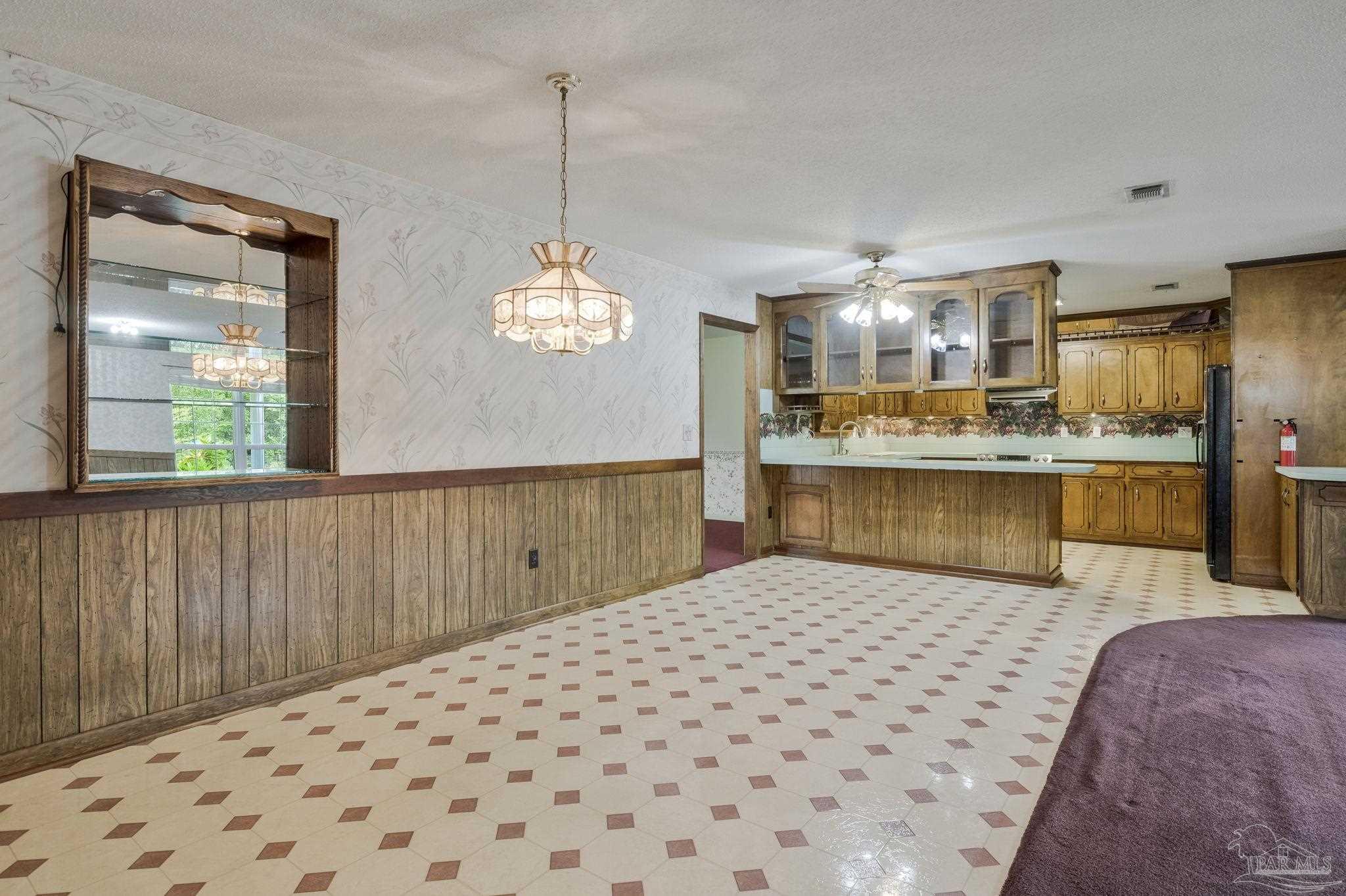 4411 Pace Lane Pace, FL 32571 - Photo 49 of 68 a large kitchen with kitchen island stainless steel appliances a large counter top a sink a stove and a refrigerator