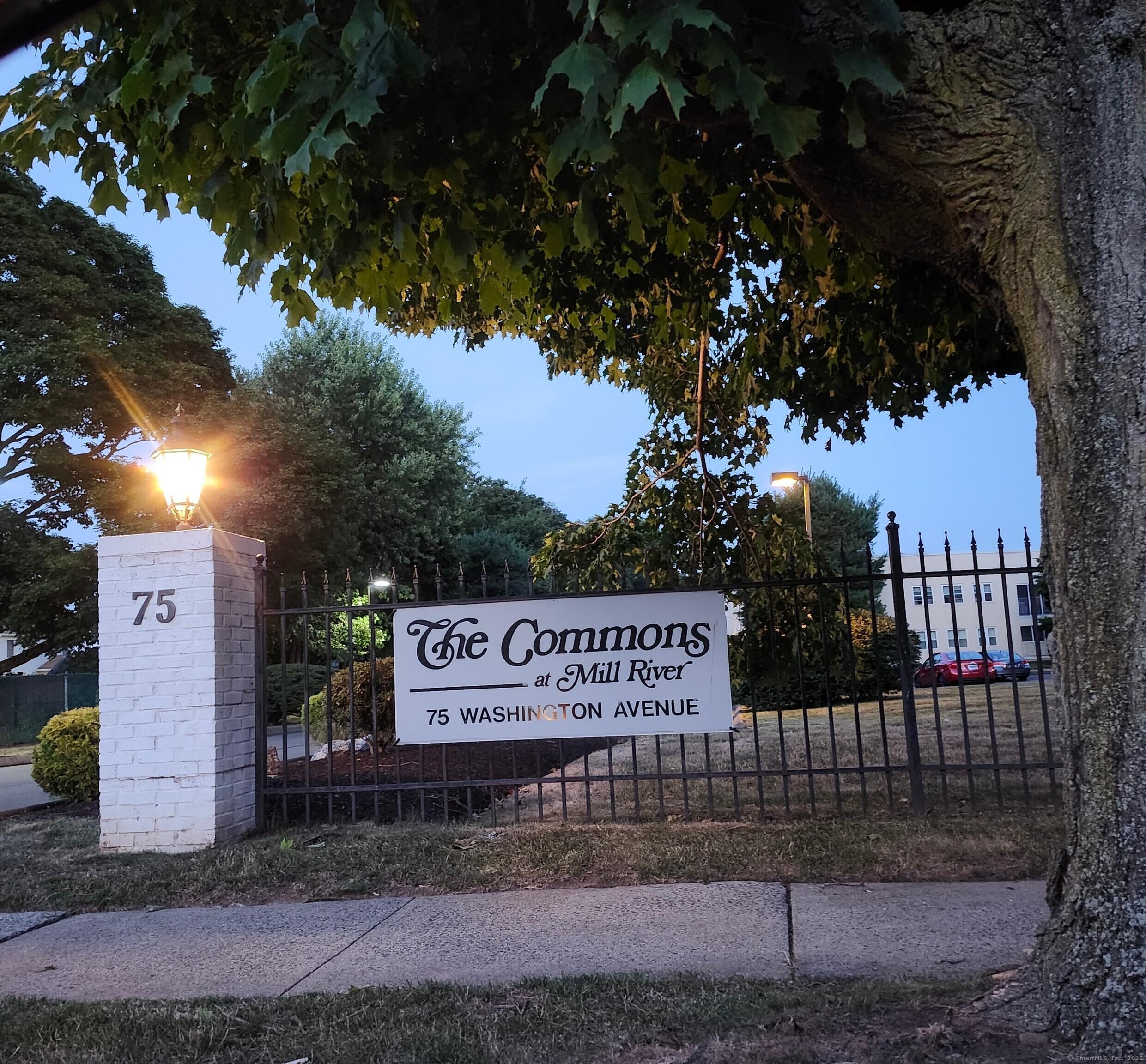 a view of a park with iron fence