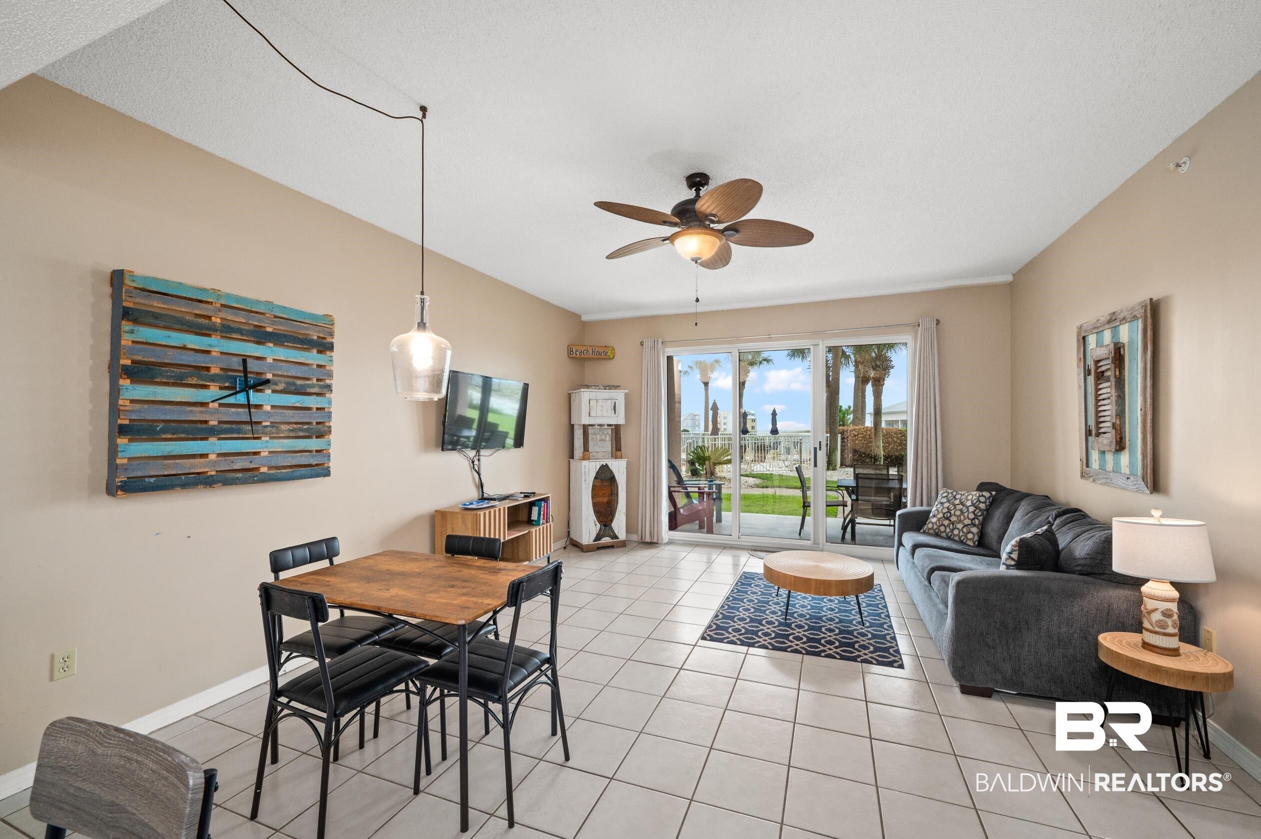1380 Fort Morgan Road, Unit 106 Gulf Shores, AL 36542 - Photo 3 of 20 Dining space with light tile patterned floors, baseboards, and a ceiling fan