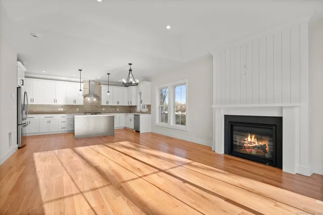 a large kitchen with kitchen island a sink stainless steel appliances and cabinets