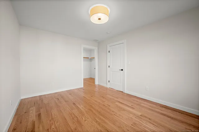 a view of a room with wooden floor