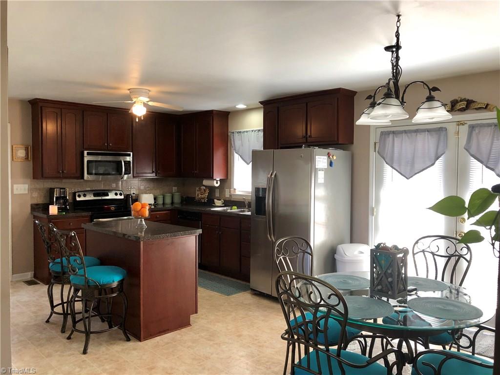 920 East Meadow Road Eden, NC 27288 - Photo 5 of 18 roomy kitchen and dining with all appliances included, patio doors to deck