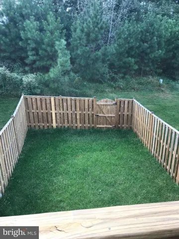 a view of a backyard with a wooden fence