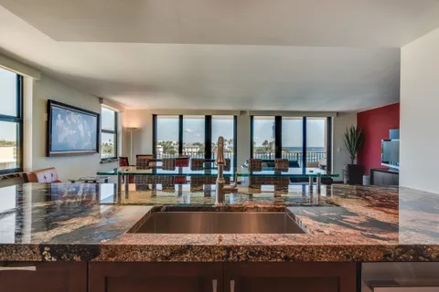 a kitchen with stainless steel appliances granite countertop a sink and stove