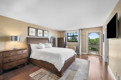 a view of a hallway with wooden floor and door