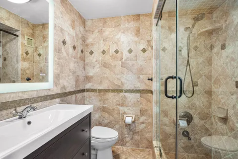 a bedroom with a bed a bookshelf and a chair