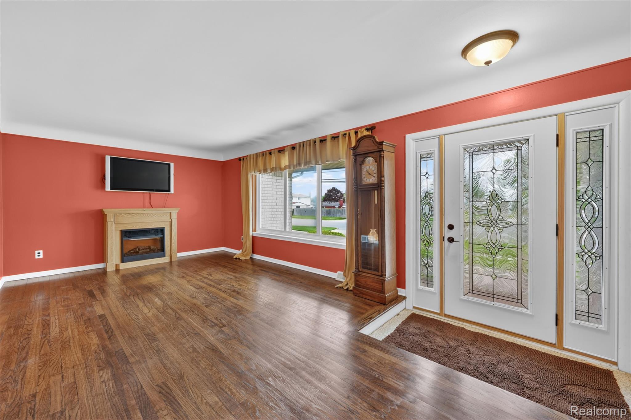 12014 Common Road Warren, MI 48093 - Photo 5 of 30 Foyer entrance with dark wood finished floors and an electric fireplace