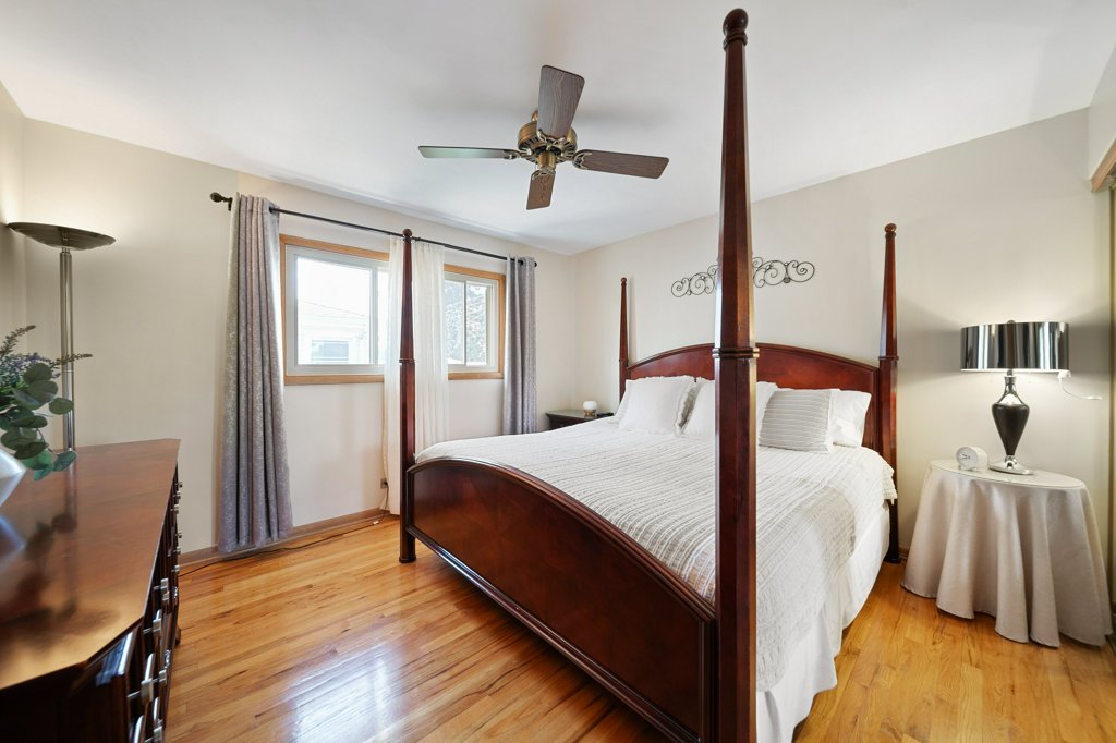 365 West Myrick Avenue Addison, IL 60101 - Photo 17 of 49 a bedroom with a bed and wooden floor