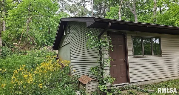 a view of a house with a large tree