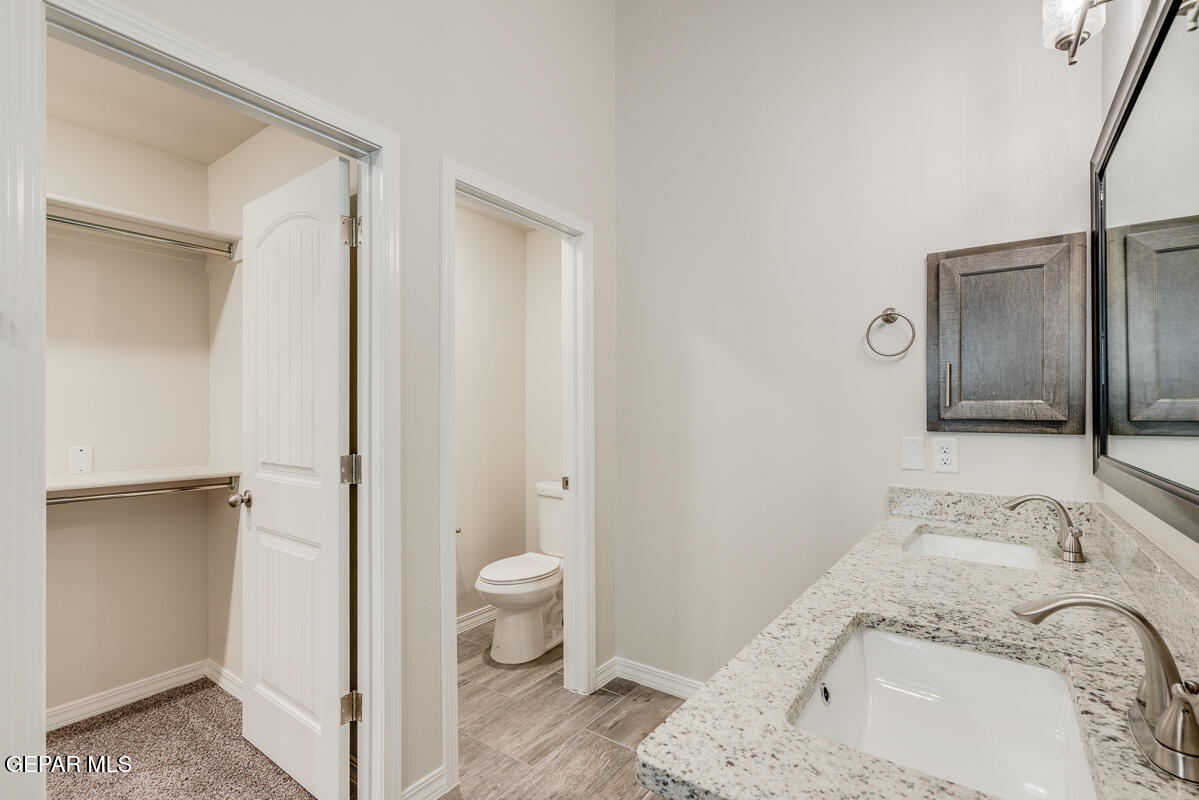 6054 Summer Ridge Santa Teresa, NM 88008 - Photo 21 of 25 a spacious bathroom with a granite countertop sink toilet and shower