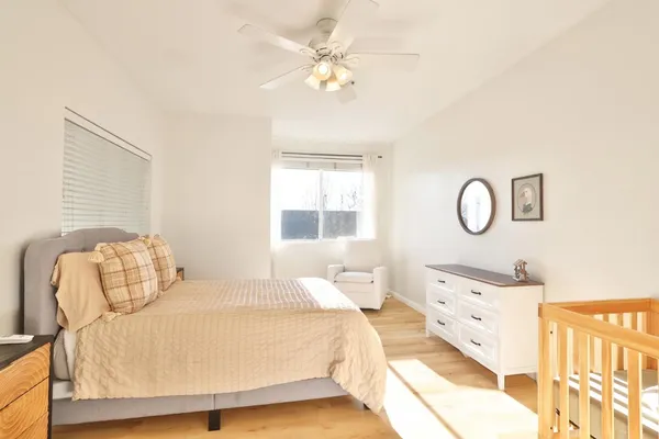 a bedroom with bed and a window