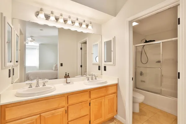 a bathroom with a double vanity sink mirror double and shower