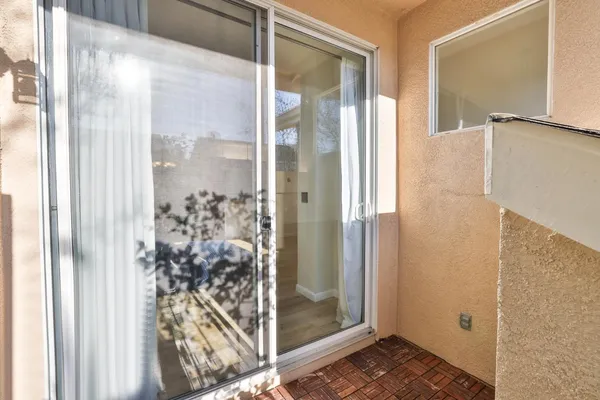 a bathroom with a glass shower door and a glass door