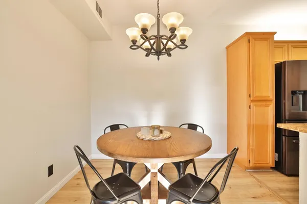 a view of a dining room with furniture and chandelier