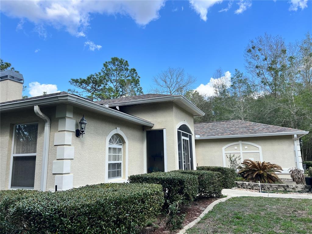 1995 East Newhaven Street Inverness, FL 34453 - Photo 2 of 48 a front view of a house with garden